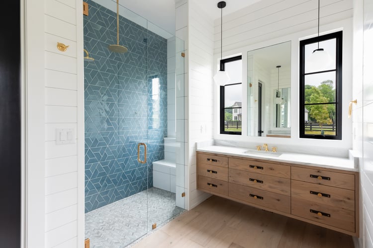 Bathroom Renovation Remodel with Curbless Walk-In Shower with Blue tile and Vanity with Marble Countertop