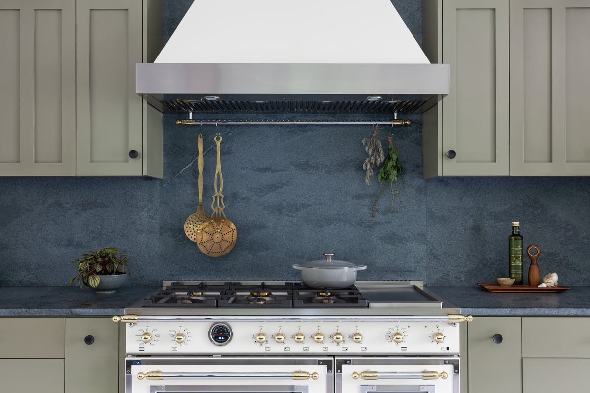 Statement Backsplash using Alberene Soapstone and Bertazzoni range in Laurie March's Kitchen featured in House Beautiful