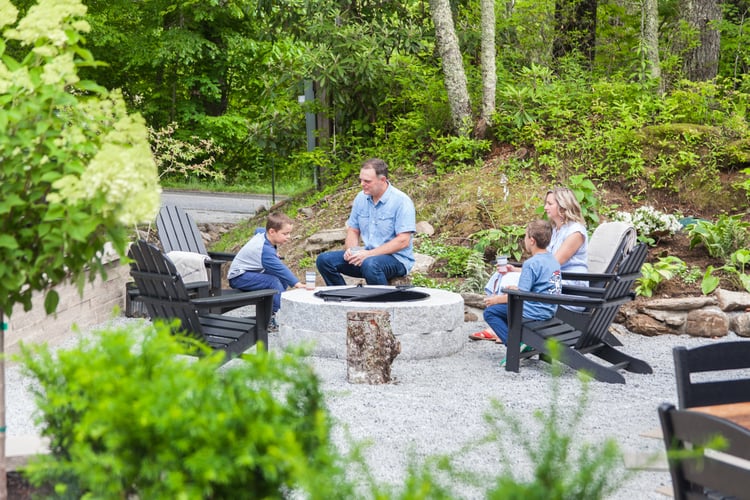 Family gathering around Eastern Gray DIY fire pit in North Carolina outdoor living space